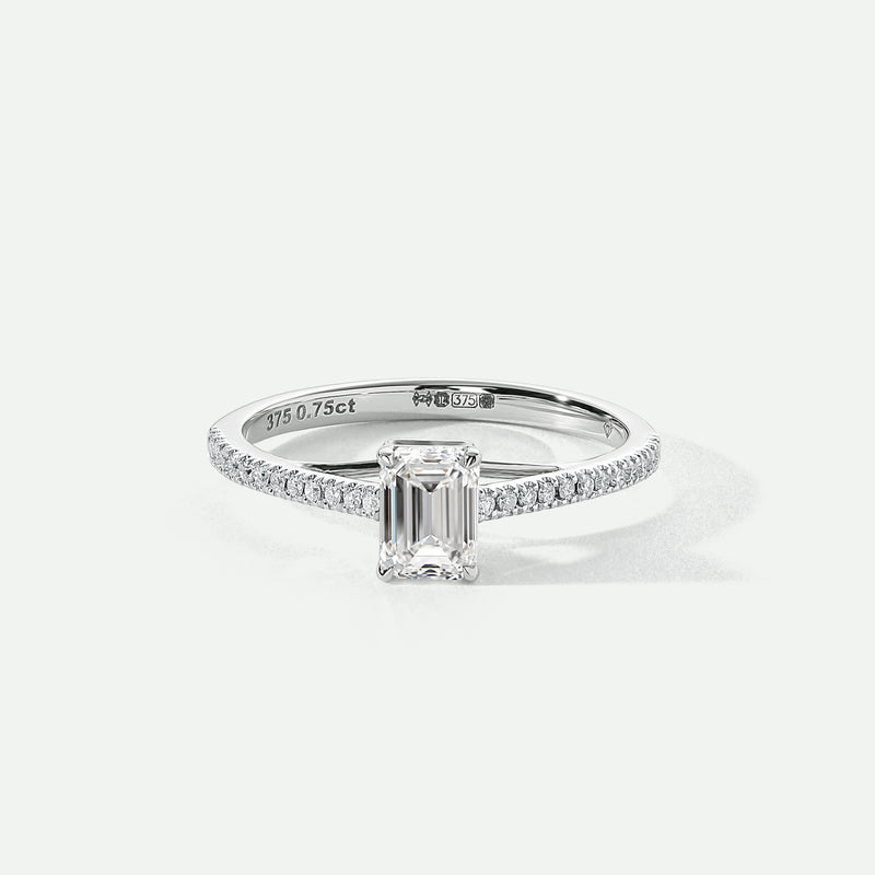 A 9ct white gold ring featuring an emerald cut lab grown diamond centerpiece with pavé set lab grown diamonds on the shoulders.