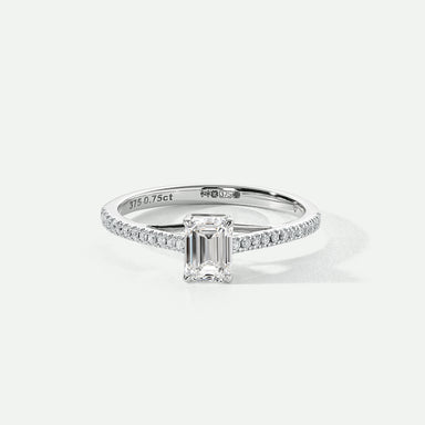 A 9ct white gold ring featuring an emerald cut lab grown diamond centerpiece with pavé set lab grown diamonds on the shoulders.