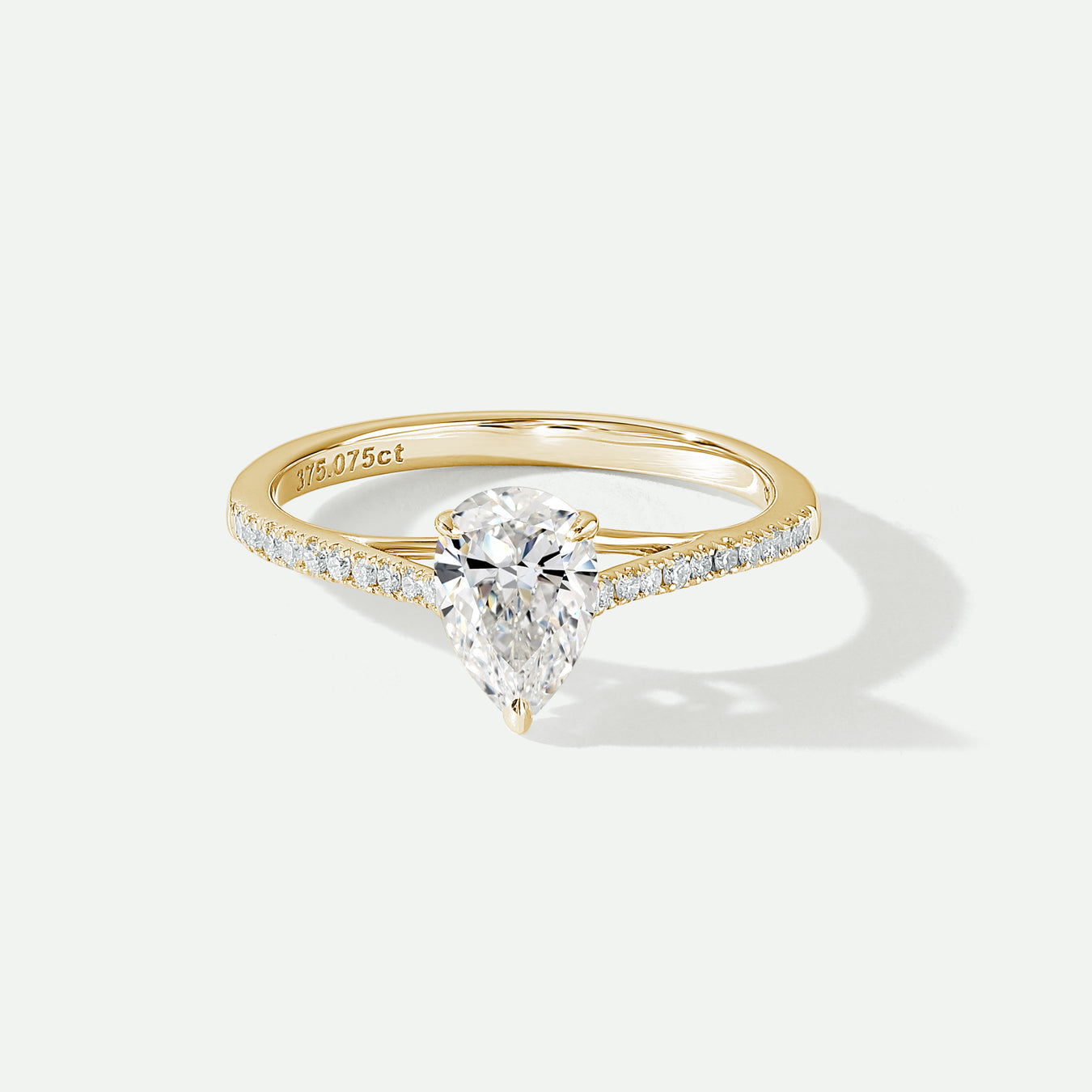 Pear Cut Solitaire engagement ring with diamond set shoulders made with lab grown diamonds